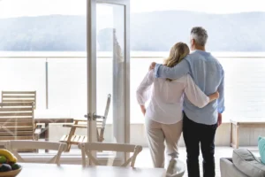Mature couple looking at the view in their waterfront home