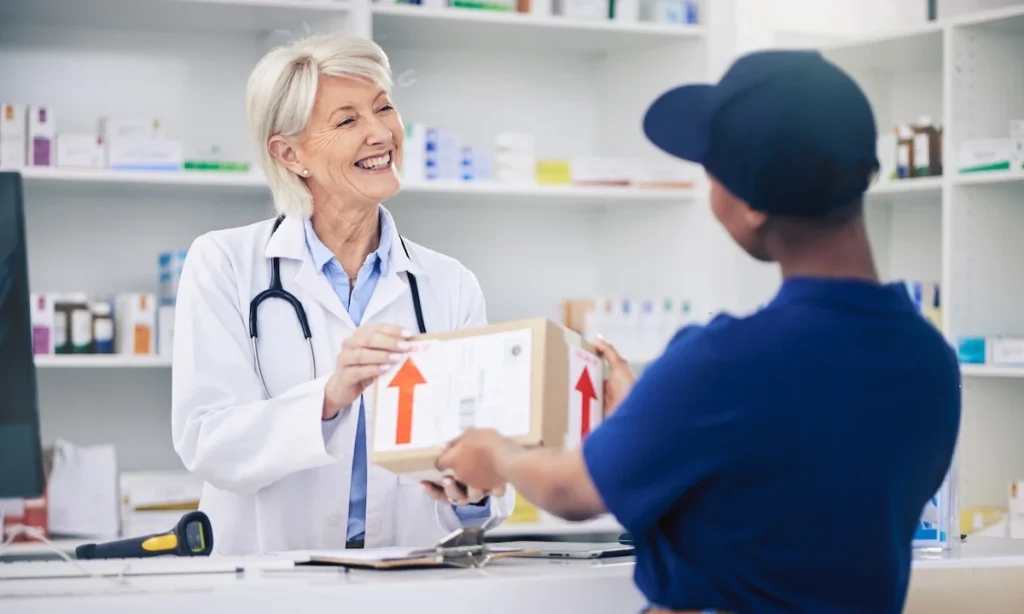 Pharmacist, package and delivery with woman in drug store for medical supplies with courier service. Healthcare professional, female employee and parcel with medicine in pharmacy for ecommerce.