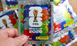 Hand holding Panini FIFA World Cup 2026 trading card sticker packs, foil booster packets for football soccer tournament collectors