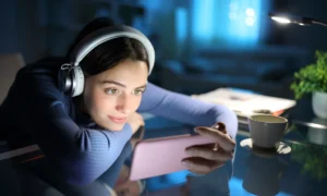 Woman watching media on smart phone in the night at home