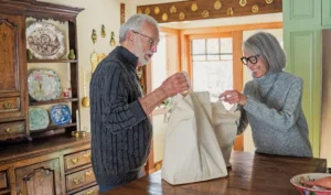 Man and woman arriving home with shopping