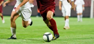 Soccer players running after the ball