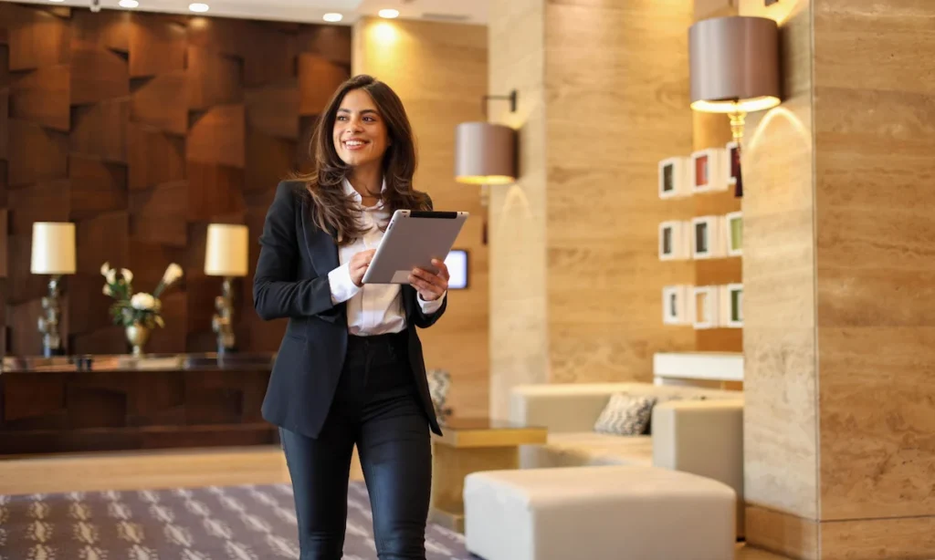 Young, ambitious businesswoman using tablet on the move