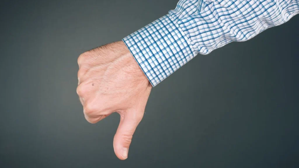 Dislike and disapprove hand gesture with thumb down