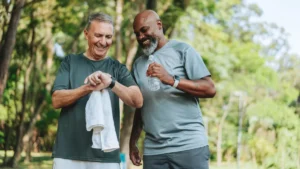 Elderly friends walking in a public park. Smartwatch