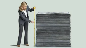 Woman Measuring Stack Of Money