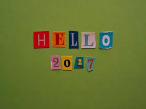 Hello 2027 message with colorful cutout letters on green background