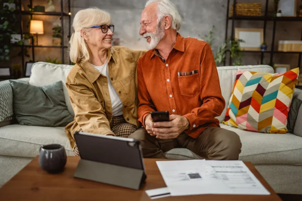 Senior couple do contactless payment and control bills on tablet