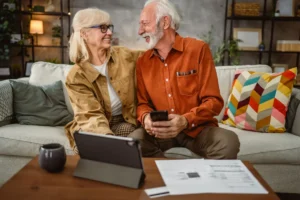 Senior couple do contactless payment and control bills on tablet