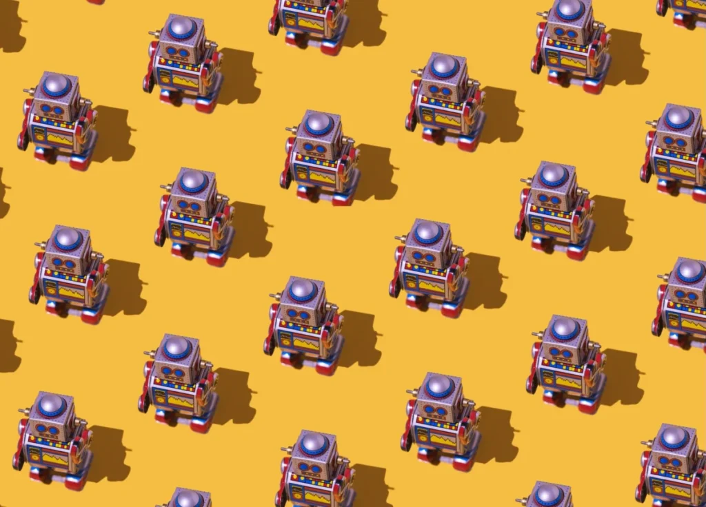 Pattern of retro tin toy robots with clocks and displays painted on yellow background. Concept of vintage, old, nostalgia, toy and android.