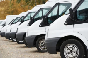commercial delivery vans in row at parking place of transporting
